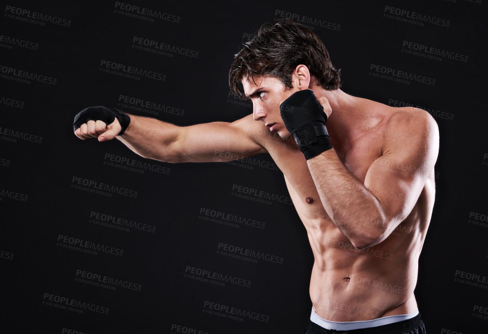 Buy stock photo Fitness, boxing and man punching in studio for exercise, challenge or competition training for gym. Power, muscle or serious champion boxer at mma workout with confidence, fight and black background