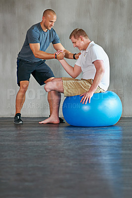 Buy stock photo Physical therapy, balance and exercise ball with a man with a disability and physio consultation for rehabilitation. Physiotherapy, help and workout for health with helping and wellness for mobility