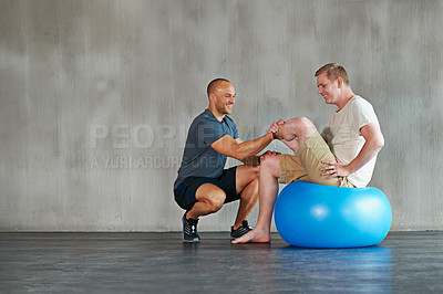 Buy stock photo Physical therapy, happy and gym ball with a man with disability and physio advice for rehabilitation. Physiotherapy, trainer and healthcare professional with helping and wellness with mobility check