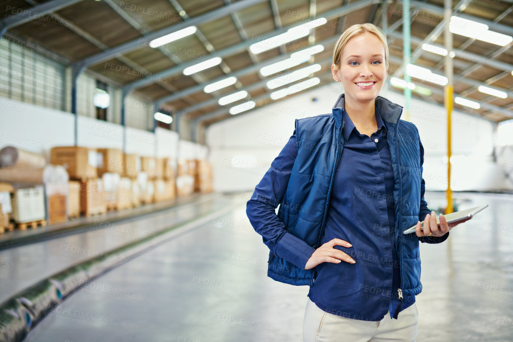 Buy stock photo Shot of a young woman working in a warehouse