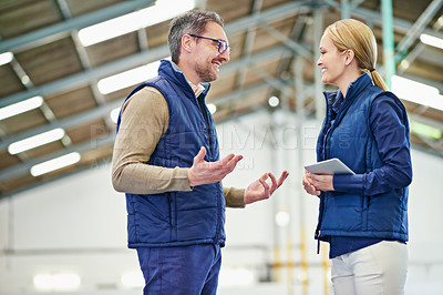 Buy stock photo Male manager, meeting and conversation with tablet in warehouse for consultation with leadership in industry. Female person, administration and project management for trade services in facility