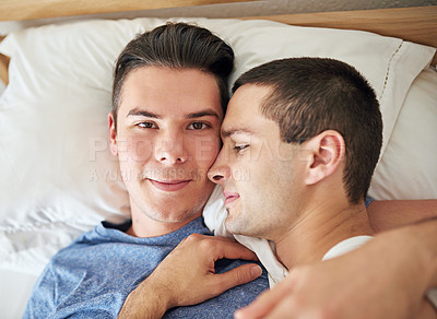 Buy stock photo Portrait, men and top view of gay couple in bed at home to relax, embrace and bonding together in the morning. Lgbtq, face and people in bedroom for love, connection and healthy relationship in house