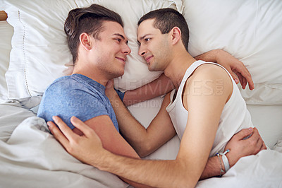 Buy stock photo Smile, men and top view of gay couple in bed at home to relax, embrace and bonding together in the morning. Lgbtq, above and happy people in bedroom for love, connection and healthy relationship