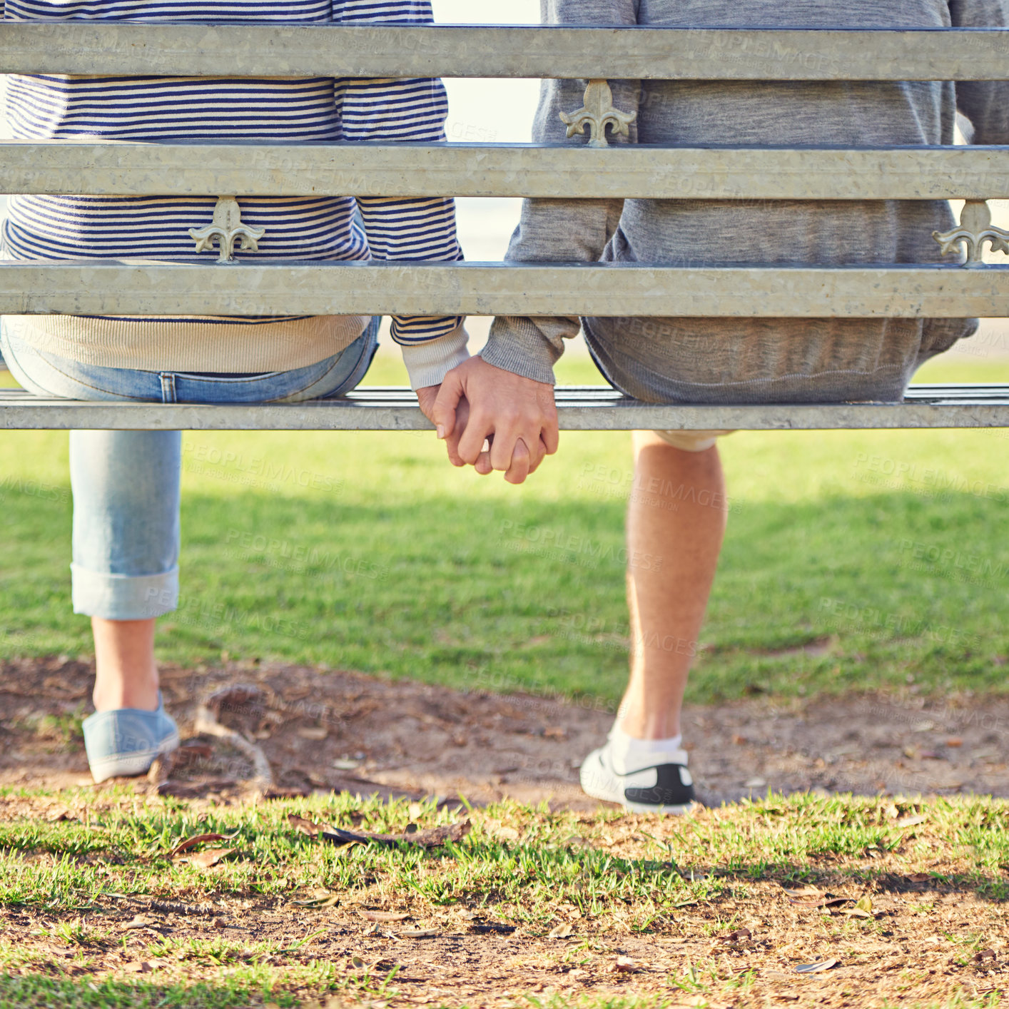 Buy stock photo Love, holding hands and couple or people, grass and marriage on bench in park. Affection, romance and support or trust from partner in nature, relationship partnership on holiday for relax in spring