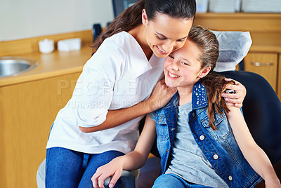 Buy stock photo Pediatric, dental clinic or dentist hug girl in consultation office for exam, comfort or teeth whitening discussion. Oral care, help or woman orthodontist embrace kid with trust, safety or gratitude