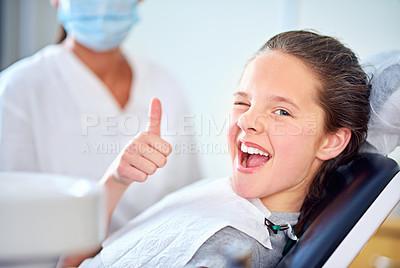Buy stock photo Portrait of a young girl sitting in a dentist's chair giving a thumbs up