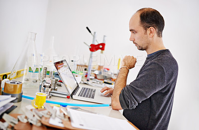 Buy stock photo Man, laptop and equipment in factory, brewery and thinking with ideas, research and development. Person, computer and vision with info on web for alcohol, craft beer and tools on desk in warehouse