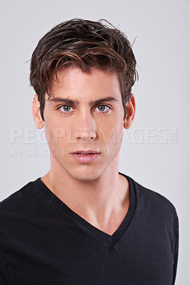 Buy stock photo Handsome man, portrait and style with hair, fashion or tshirt on a gray studio background. Attractive male person, caucasian or model with trendy hairstyle, clothing or barber treatment for grooming