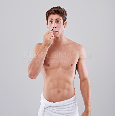 Buy stock photo Tweezer, nose and man on gray background for wellness, hair removal and beauty treatment in studio. Skincare, dermatology and isolated person with health tools for cosmetics, grooming and hygiene