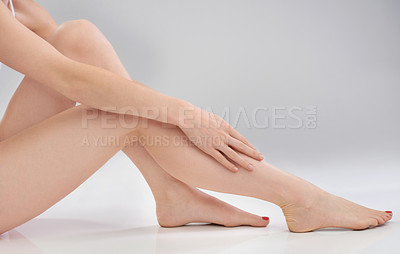 Buy stock photo Cropped image of a woman touching her smooth legs