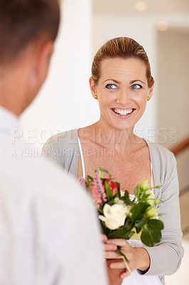 Buy stock photo Smile, happy and woman with flowers for wedding, marriage and love with man for bonding in background. Female person, girl and wife with husband for bouquet, union and partnership of couple together