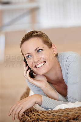 Buy stock photo Happy, woman thinking or phone call in home talking or speaking in living room for communication. Chat, mobile or person with smile in conversation to relax on couch or sofa in a house for a break 