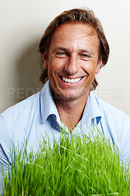 Buy stock photo Portrait, businessman and nature with grass in office for sustainable, eco friendly and environment. Male person, clean energy and corporate with plant by background for turf, ecology and climate