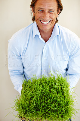 Buy stock photo Man, smile and portrait with turf for grass, artificial and green for material, landscape and lawn. Mature male and happy with product for root and soil for planting on ground and nature in studio
