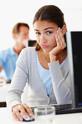 Buy stock photo Portrait, bored and business woman on computer in creative startup office at desk for coworking. Face, serious or tired professional on desktop with mouse, entrepreneur or designer thinking of career