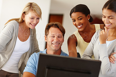 Buy stock photo Shot of a work team gathered around a computer