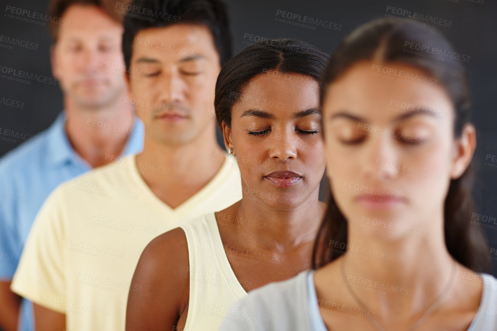Buy stock photo Diversity, people and row with eyes closed for meditation in dark background for peace, calm and healthy mind. Group, standing and concentrate at yoga for health or hobby with friendship and wellness