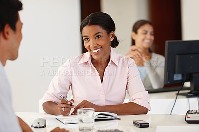 Buy stock photo Shot of an attractive african woman talking to a coworker at her desk