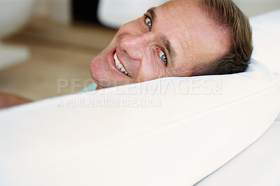 Buy stock photo Portrait, man or sofa to relax at weekend in peace, health or wellness as easy, self care or holiday. Tired, happy or mature male person on couch as lazy, break or comfort as rest and relaxation