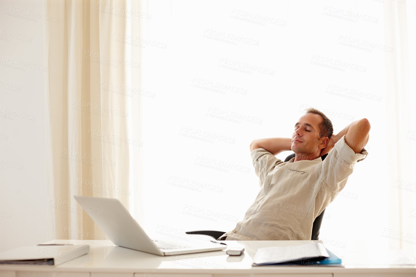 Buy stock photo Businessman at work taking a minute to break away from his tasks