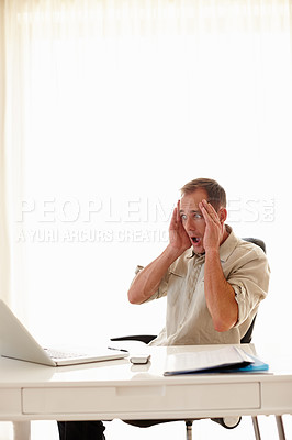 Buy stock photo Shot of a businessman looking distressed in his office