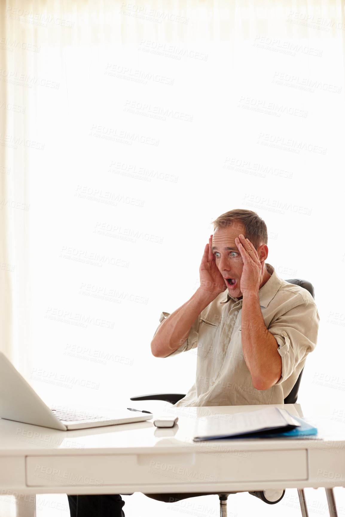 Buy stock photo Shot of a businessman looking distressed in his office