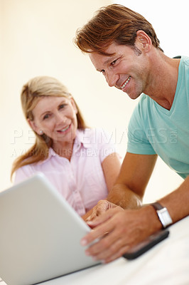 Buy stock photo Laptop, teamwork and happy business people in a meeting for creative, research or checking feedback and review. Computer, training or businessman with mature mentor for learning, questions or support