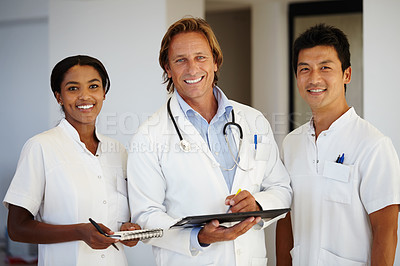 Buy stock photo Portrait of three medical professionals working with a digital tablet