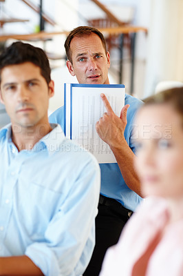 Buy stock photo Office, portrait and confused businessman with point at paper for corporate, planning or question. Group of employees, document and accountant with expression for budget problem, frustrated or stress