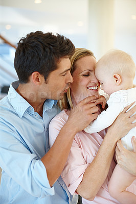 Buy stock photo Mother, father and baby or love connection in home with childhood development, security or bonding. Man, woman and kid embrace together as family peace with hugging parent care, comfort or support