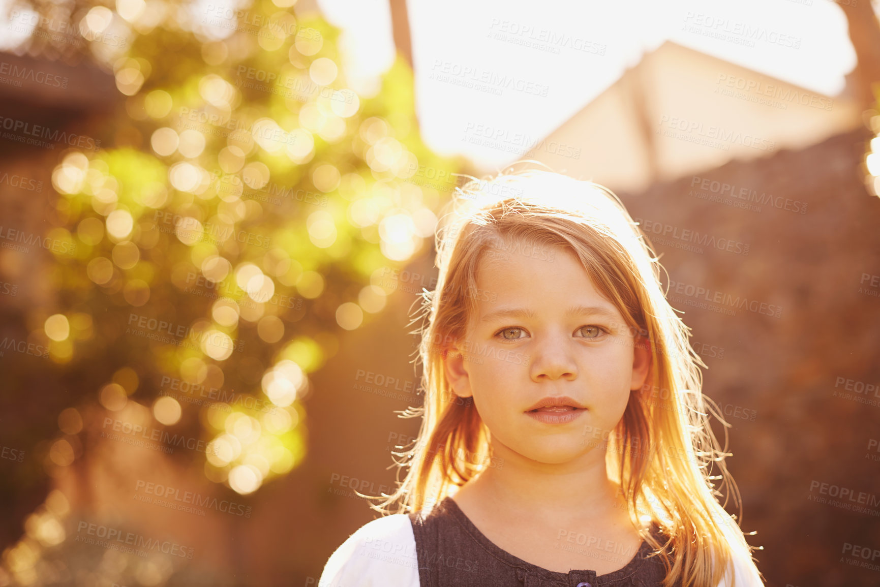 Buy stock photo Portrait, girl and kid outdoor in summer at backyard, nature or cute student alone at park with bokeh. Face, serious and adorable young child in garden on vacation or holiday with sunshine in Sweden