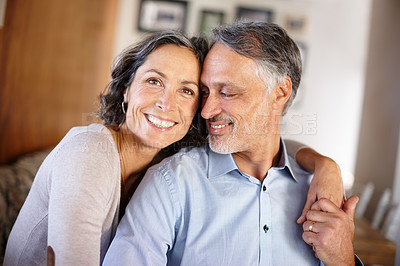 Buy stock photo Mature couple, happy and hug in home for portrait with bonding, care and together with love in living room. Senior people, man and woman with embrace, marriage and holding hands for support in lounge
