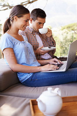 Buy stock photo Couple, woman and man with coffee, laptop and relax with partner, girl and girlfriend in patio of home. Summer, internet and female person online for search of resort or hotel for date in holiday