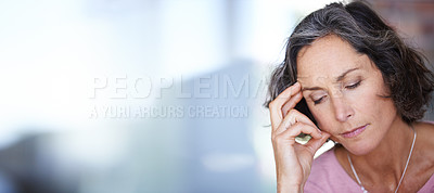 Buy stock photo Shot of a mature woman touching her temple with her eyes closed