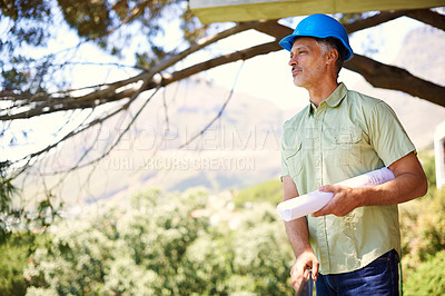 Buy stock photo Architect, floor plan or blueprint in outdoor construction site for building house, apartment or residence. Mature, male contractor and layout of project hard hat on for safety, protection or shelter