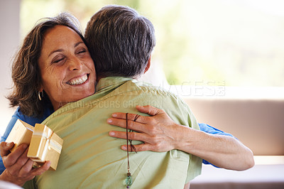 Buy stock photo Love, hug and mature couple with gift for birthday, valentines day or anniversary celebration. Gratitude, romance and happy man giving woman a box, present or surprise for romantic gesture in house