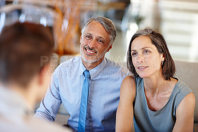 Buy stock photo A cropped shot of a mid adult couple having a meeting with a young businessman