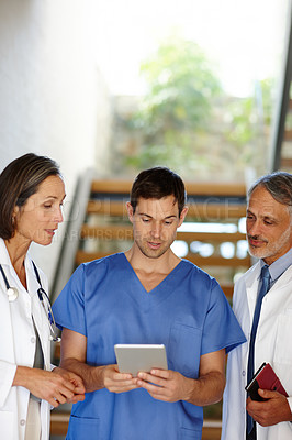Buy stock photo Medical, team and talking or working with tablet, hospital nurse with doctor in discussion conversation or patient result. Health, collaboration on tech for research, consulting surgeon on healthcare