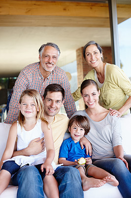Buy stock photo A portrait of a happy multi-generational family gathered at home in their living room