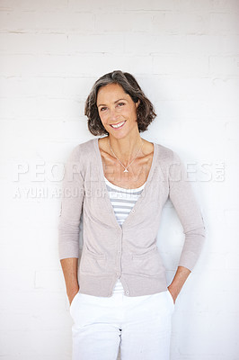 Buy stock photo A mature woman posing confidently while standing against a white studio wall
