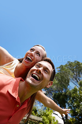 Buy stock photo Outdoors, couple and piggyback in nature for love, marriage and bonding by flying game. Happy people, freedom and laughing on holiday for humor and commitment to fun, loyalty and connection on date