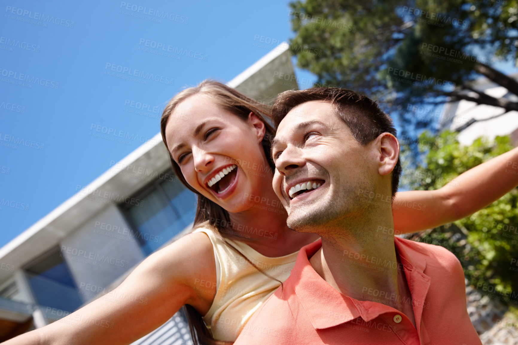 Buy stock photo Outdoors, couple and piggyback on weekend for love, marriage and bonding by flying game. Happy people, freedom and laughing on holiday for humor and commitment to fun, loyalty and connection on date