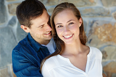 Buy stock photo Outdoors, couple and portrait for love, holiday and romance or care on wall background. Happy people, relaxing and smiling for pride in relationship or commitment, loyalty and connection on date