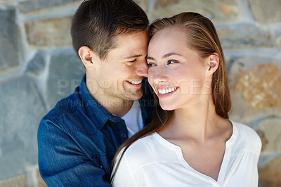Buy stock photo Outdoors, couple and embrace for love, touch and romance or care on wall background. Happy people, relaxing and smile for pride in relationship or commitment, loyalty and connection on holiday