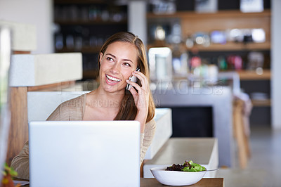 Buy stock photo Woman, laptop and home with phone call in table with conversation and break from remote work as journalist. Female person, laugh and freelancer in  living room or lounge with mobile discussion 