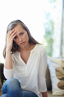 Buy stock photo Woman, home and portrait with anxiety on sofa for stress, worried or concern or tension. Female person, house and headache with hand for trouble or fear, unhappy or miserable or mental health
