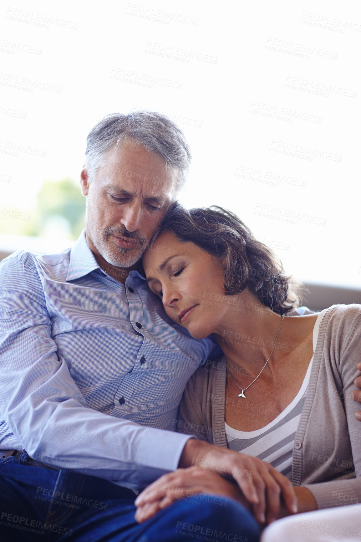 Buy stock photo Mature couple, hug and relax on couch for love, commitment and affection in marriage. People, home and comfortable in embrace on sofa and care in relationship, romance and bonding together in lounge