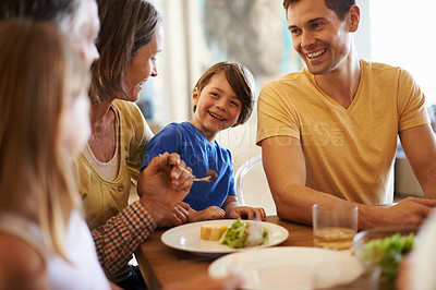 Buy stock photo Shot of a happy family enjoying dinner together