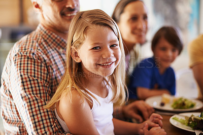 Buy stock photo Portrait of a little girl sitting on her grandfather's lap at dinner