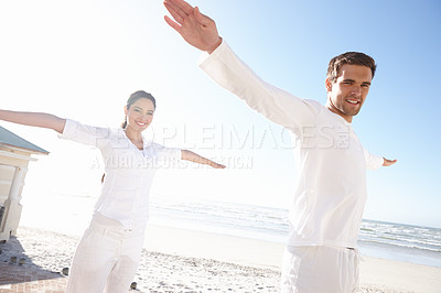 Buy stock photo Yogi couple, pose or beach in mindfulness, practice of meditation as health, fitness or wellness. Man, woman or eyes closed in peace as spiritual, zen or yoga for balance, awareness and gratitude